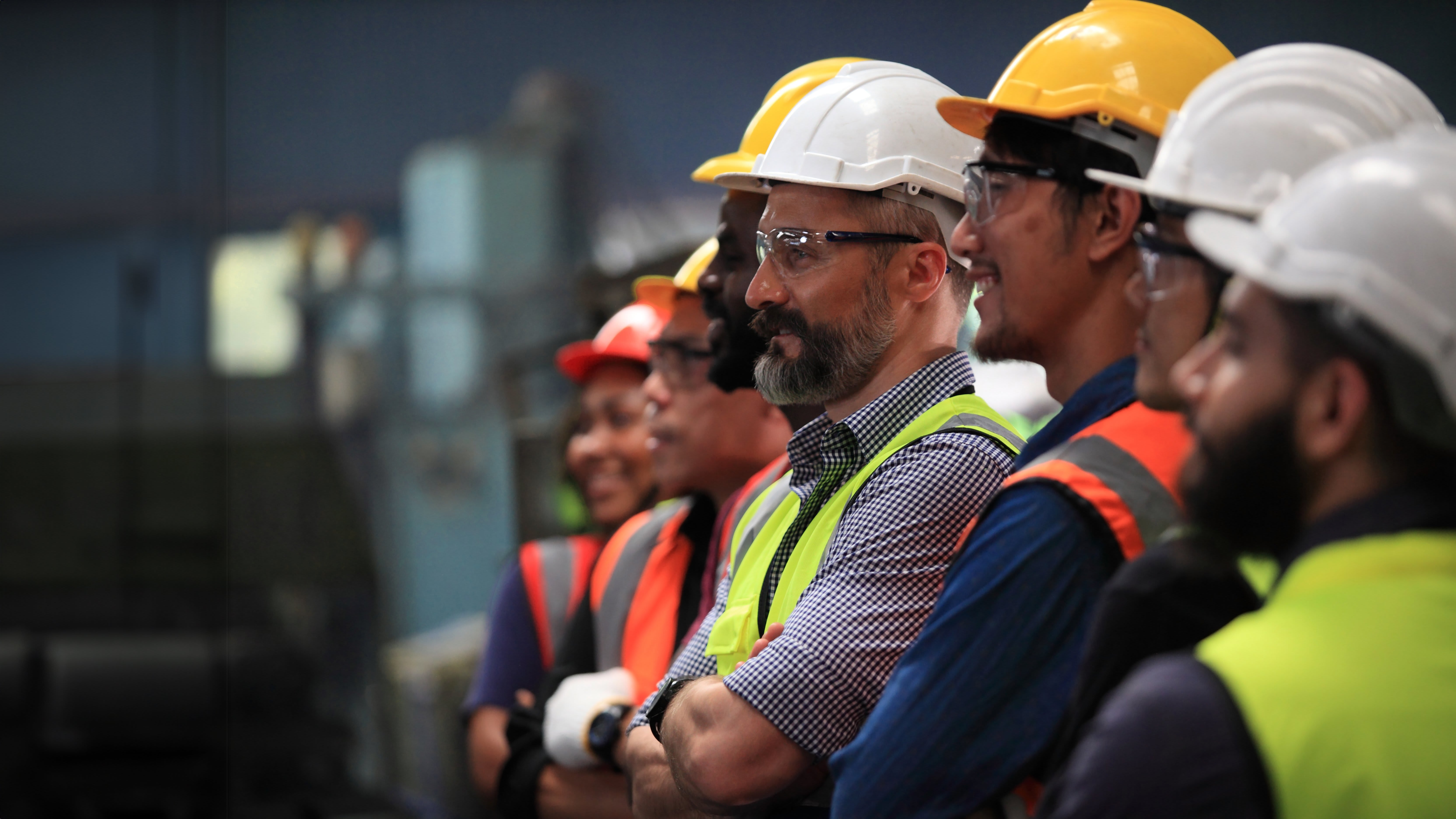 somw craftsman in a row wearing safety equipment